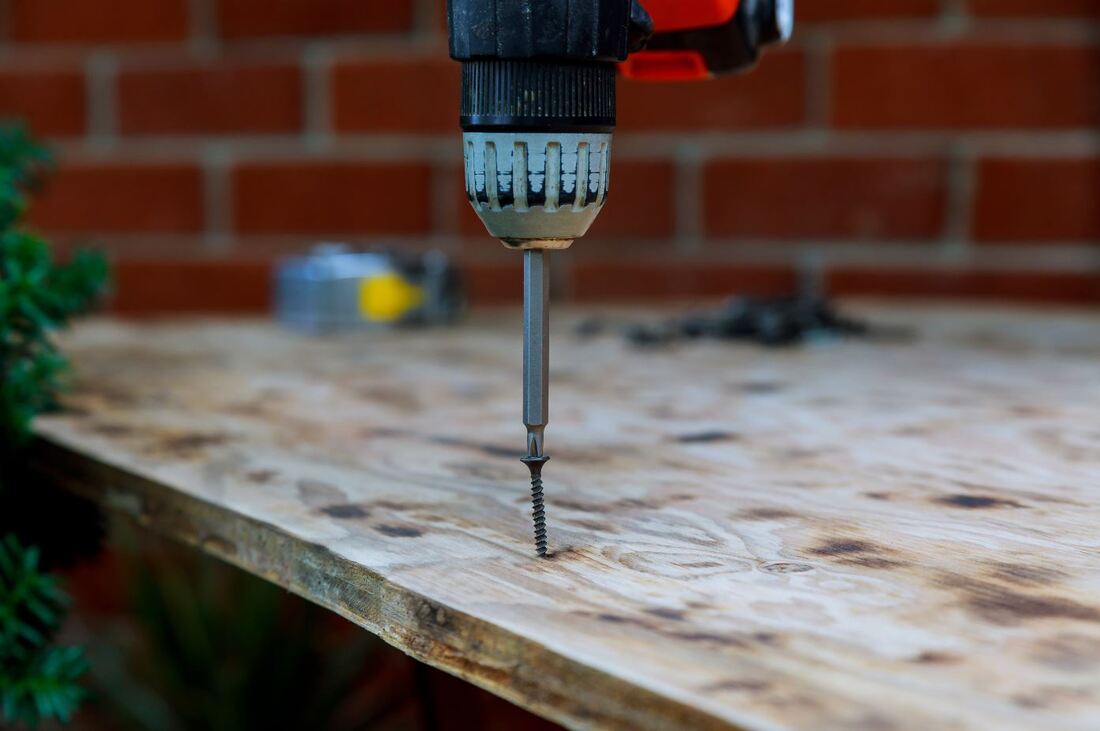 Screwing a screw into wood