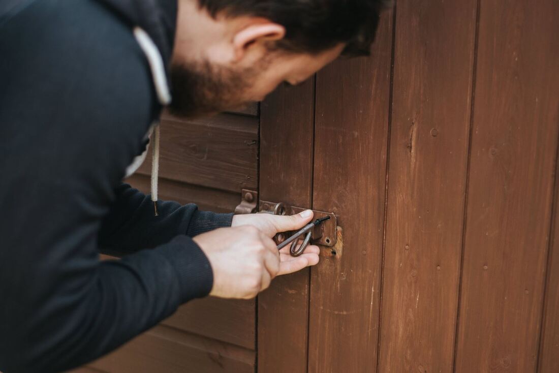 Man fixing a hinge on a wooden door